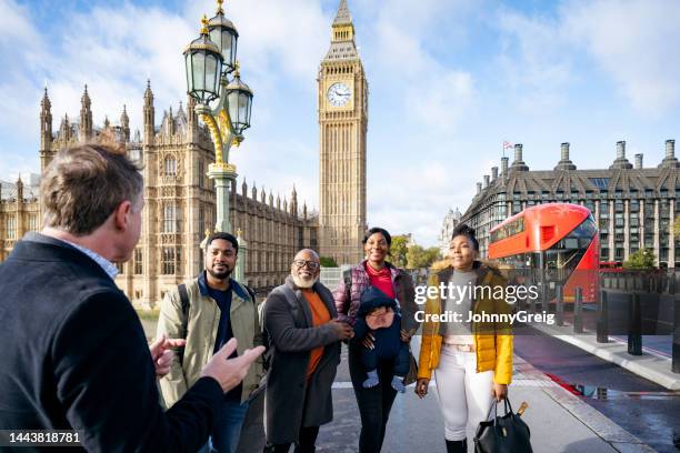 vacationing black family enjoying guided tour of london - person falls from westminster bridge stock pictures, royalty-free photos & images