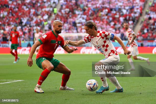 Luka Modric of Croatia and Sofyan Amrabat of Morocco battle for the ball during the FIFA World Cup Qatar 2022 Group F match between Morocco and...