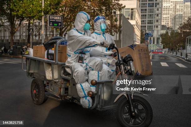 Epidemic control workers wear protective clothing to protect against the spread of COVID-19 as they in the street with equipment in the Central...