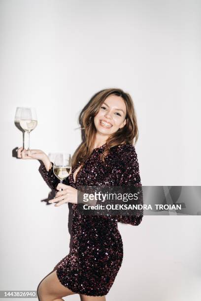 portrait with young woman with two glasses of champagne (flash light) - glitter dress stock pictures, royalty-free photos & images