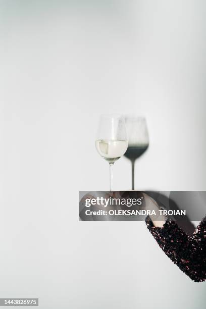 woman hand with champagne glass and harsh light - alcohol and women stock-fotos und bilder