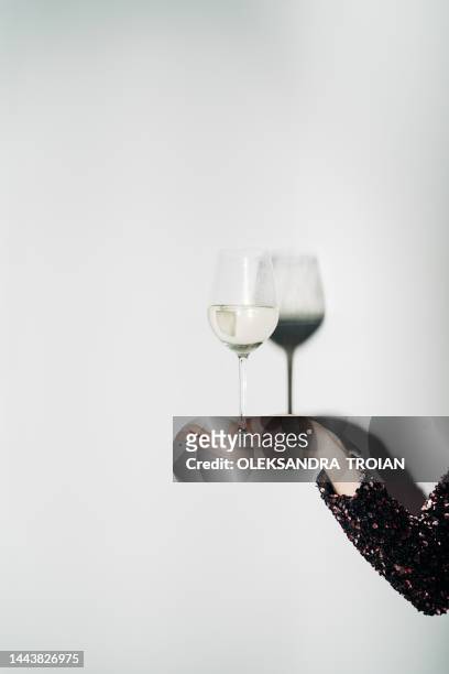 woman hand with champagne glass and harsh light - wine glasses stock pictures, royalty-free photos & images