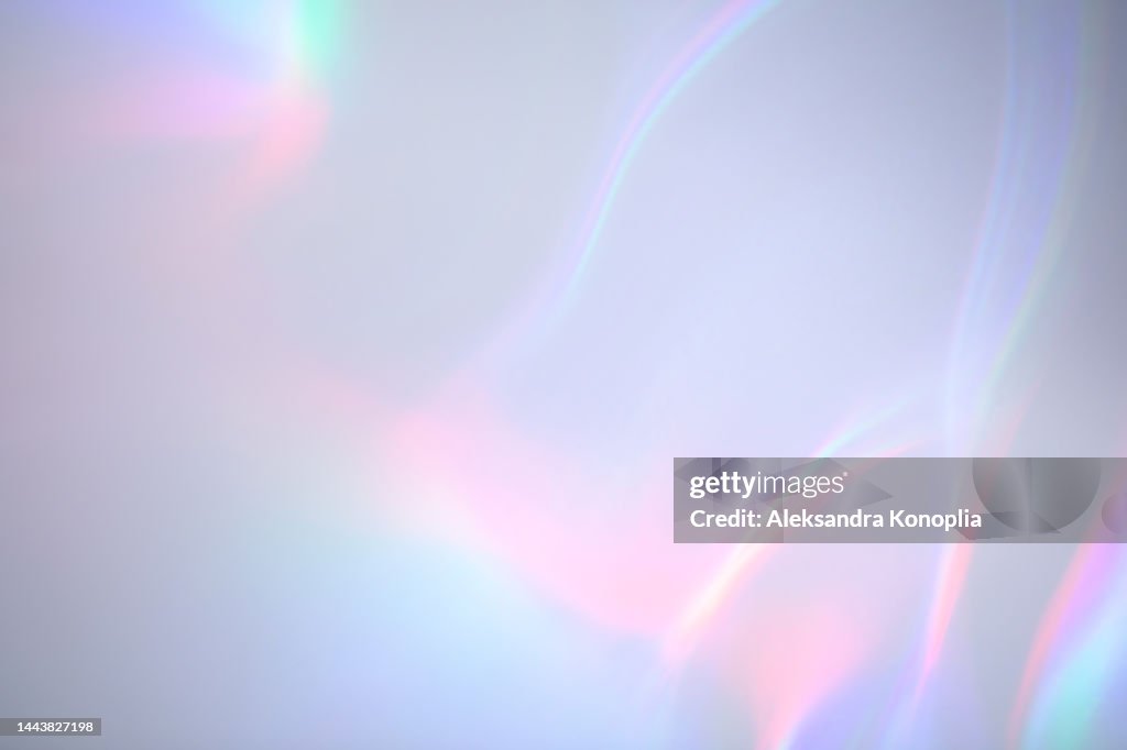 Surreal aura rainbow laser light refraction texture overlay effect on white wall
