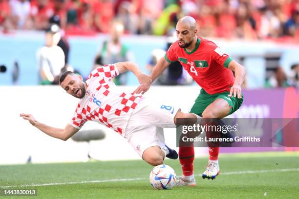 Mateo Kovacic of Croatia and Sofyan Amrabat of Morocco battle for the ball during the FIFA World Cup Qatar 2022 Group F match between Morocco and...