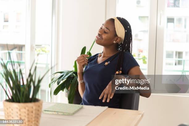 portrait of an african american student day dreaming while learning - media day creative portraits stock pictures, royalty-free photos & images