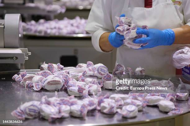 Detail of an operator handling almond polvorones during the visit to the mantecados factory of the firm La Muralla in the town of Estepa, on November...
