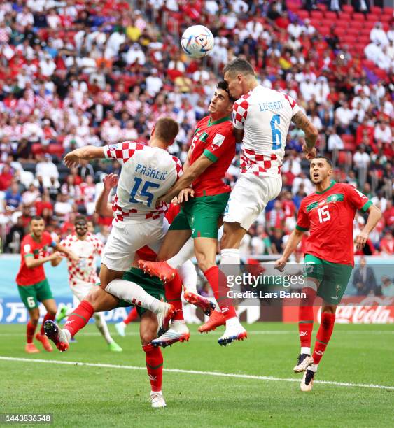 Nayef Aguerd of Morocco competes for a header against Mario Pasalic and Dejan Lovren of Croatia during the FIFA World Cup Qatar 2022 Group F match...
