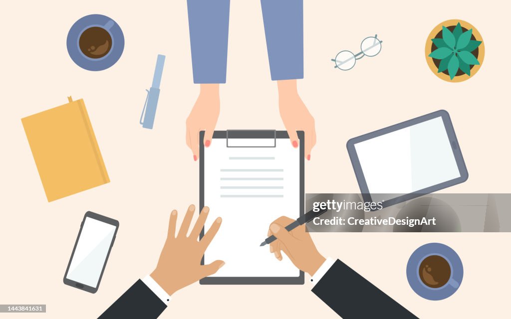 Top View Of Woman Hands Holding The Agreement And Businessman Signing. Table With Digital Tablet, Smart Phone And Coffee Cups
