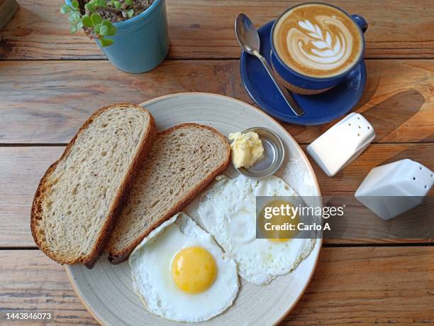fried eggs and cappuccino - sunny side up stock pictures, royalty-free photos & images