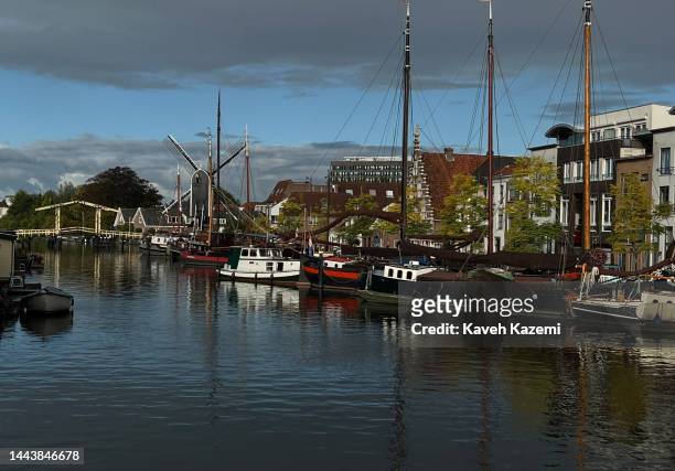 An old windmill is seen behind boats anchoring on the side of the canal on September 25, 2022 in Leiden, Netherlands.