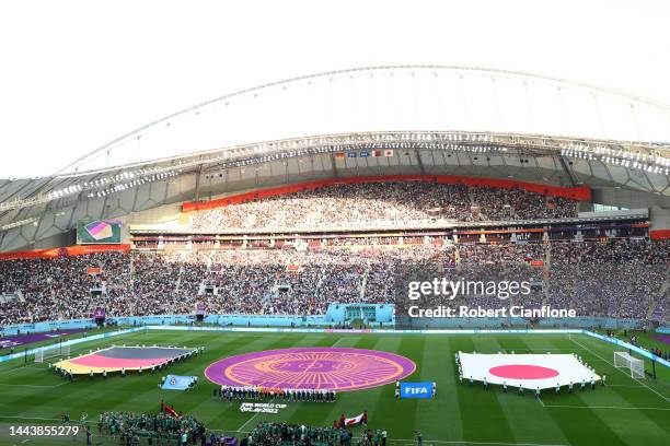 Players and match officials line up for the national anthem prior to the FIFA World Cup Qatar 2022 Group E match between Germany and Japan at Khalifa...