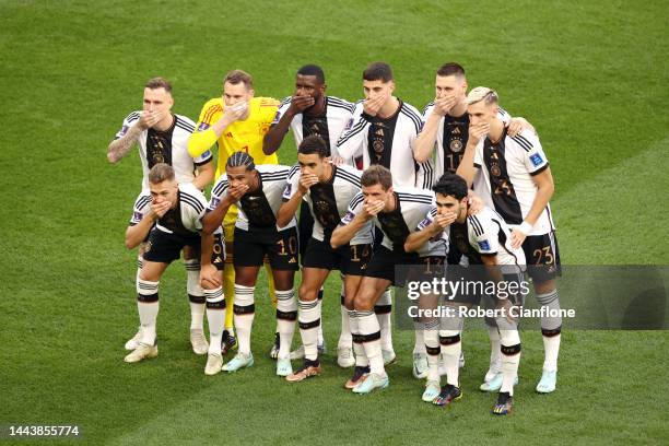 Germany players pose with their hands covering their mouths as they line up for the team photos prior to the FIFA World Cup Qatar 2022 Group E match...