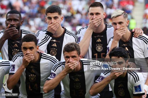 Germany players cover their mouths as they pose for a team photo during the FIFA World Cup Qatar 2022 Group E match between Germany and Japan at...