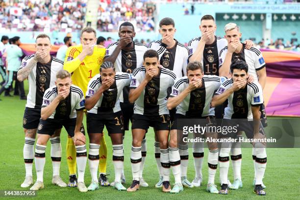 Germany players pose with their hands covering their mouths as they line up for the team photos prior to the FIFA World Cup Qatar 2022 Group E match...