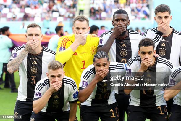 Germany players pose with their hands covering their mouths as they line up for the team photos prior to the FIFA World Cup Qatar 2022 Group E match...
