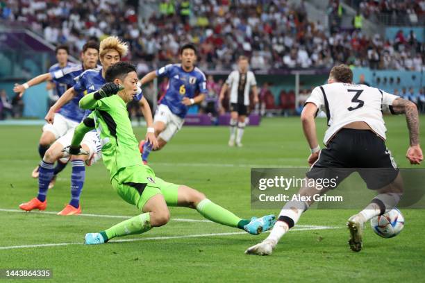 Shuichi Gonda of Japan brings down David Raum of Germany resulting in a penalty kick during the FIFA World Cup Qatar 2022 Group E match between...