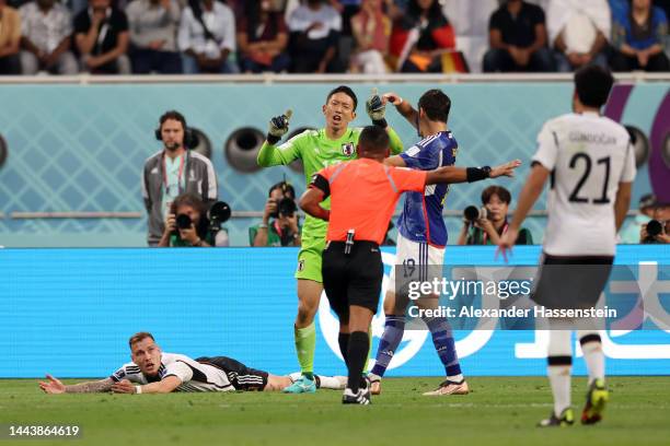 Shuichi Gonda of Japan reacts as he bring down David Raum of Germany while Referee Ivan Arcides Barton Cisneros points the penalty spot during the...
