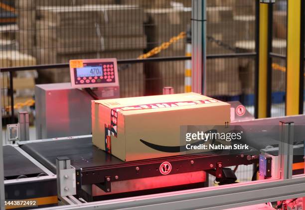 Amazon packages move on a conveyer as they pass through an labelling area at Rugeley Amazon Fulfilment Centre on November 23, 2022 in Rugeley,...