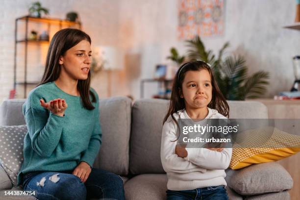 young mother scolding her daughter for being disobedient - girls arguing stock pictures, royalty-free photos & images