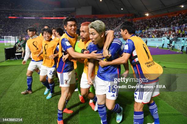 Takuma Asano of Japan celebrates scoring their second goal with their teammates during the FIFA World Cup Qatar 2022 Group E match between Germany...