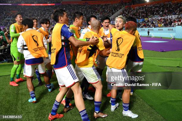 Takuma Asano of Japan celebrates scoring their second goal with their teammates during the FIFA World Cup Qatar 2022 Group E match between Germany...