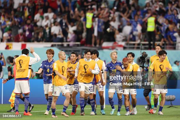 Takuma Asano of Japan celebrates with teammates after scoring their team's second goal during the FIFA World Cup Qatar 2022 Group E match between...
