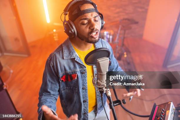 black male rapper recording a music album in a beautiful studio - nas rapper imagens e fotografias de stock