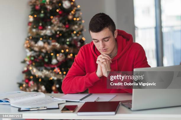 man using technology when studying at home - winter testing imagens e fotografias de stock