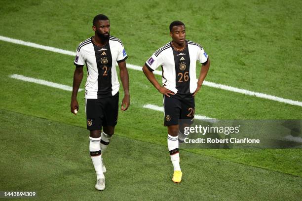 Antonio Ruediger and Youssoufa Moukoko of Germany react after the 1-2 loss during the FIFA World Cup Qatar 2022 Group E match between Germany and...