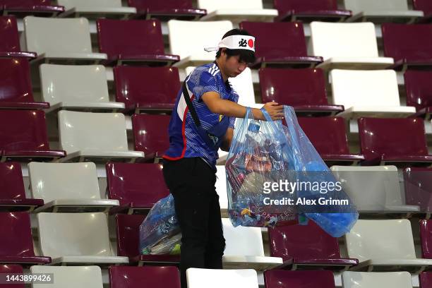Japanese fan clears rubbish from the stands during the FIFA World Cup Qatar 2022 Group E match between Germany and Japan at Khalifa International...