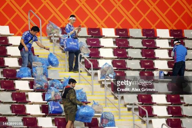 Japanese fans clear rubbish from the stands during the FIFA World Cup Qatar 2022 Group E match between Germany and Japan at Khalifa International...