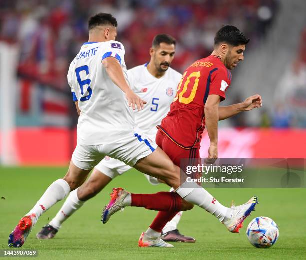 Marco Asensio of Spain battles for possession with Oscar Duarte and Celso Borges of Costa Rica during the FIFA World Cup Qatar 2022 Group E match...