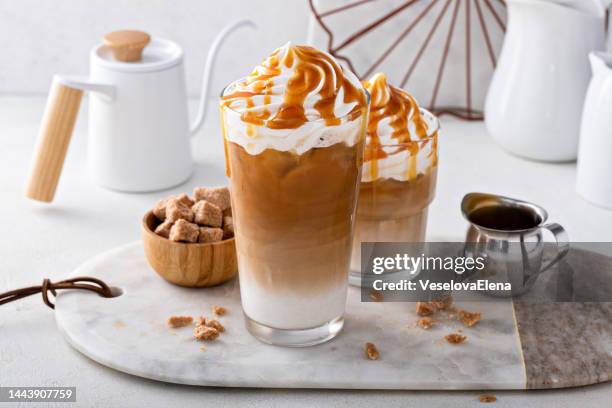 Iced caramel latte topped with whipped cream and caramel sauce