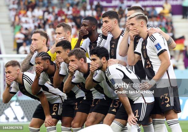 Germany’s players place their hands over their mouths in statement of defiance against Fifa before their Group E match against Japan during the FIFA...
