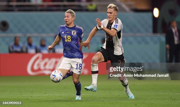 Nico Schlotterbeck fights for the ball with Japan's forward Takuma Asano during the FIFA World Cup Qatar 2022 Group E match between Germany and Japan...