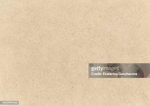 textured background made of brown paper or cardboard for design and decoration - cremefarbig stock-fotos und bilder