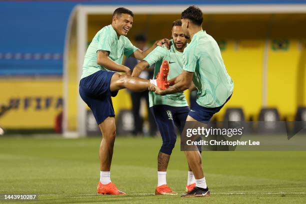 Thiago Silva, Neymar and Lucas Paqueta of Brazil warm up during Brazil match day -1 training session at Al Arabi SC Stadium on November 23, 2022 in...