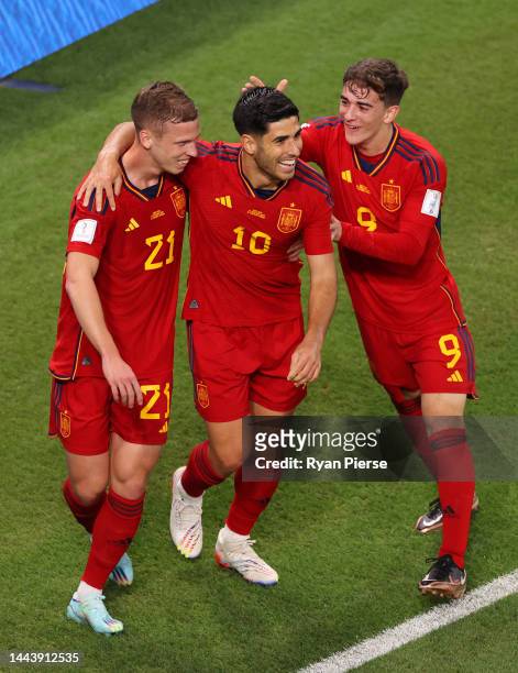 Marco Asensio of Spain celebrates with Dani Olmo and Gavi after scoring their team's second goal during the FIFA World Cup Qatar 2022 Group E match...