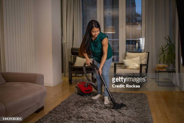 woman cleaning floor with vacuum cleaner - maid hoovering stock pictures, royalty-free photos & images