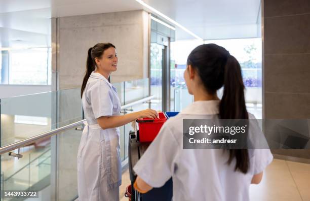 happy team of cleaners working at a hospital - hospital cart stock pictures, royalty-free photos & images