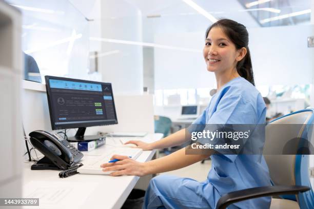 happy receptionist working at the hospital - secretary stock pictures, royalty-free photos & images