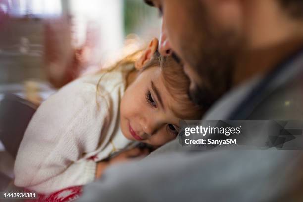 father and daughter on christmas eve - girls hugging stock pictures, royalty-free photos & images