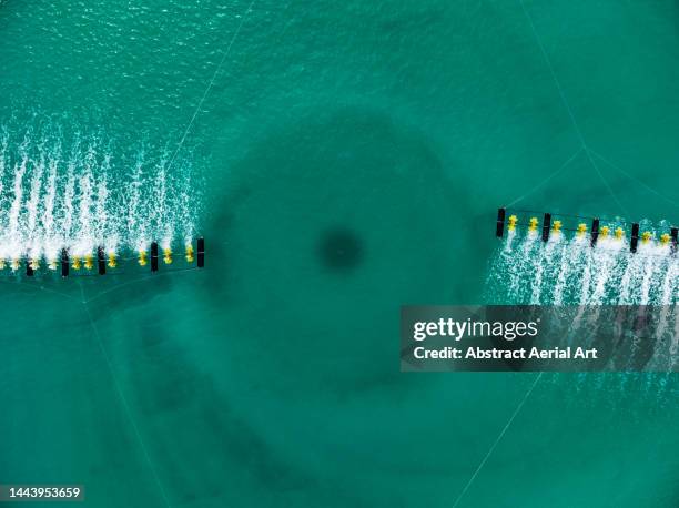 drone image looking down on a sprinkler in a water treatment tank, vietnam - reverse osmosis stock pictures, royalty-free photos & images