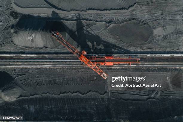 aerial image directly above an industrial machine working in a coal pit, vietnam - mines stockfoto's en -beelden