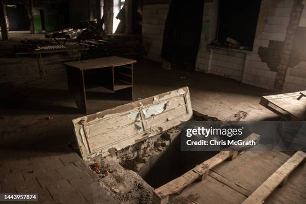 Door to a basement hole is seen at a restaurant local residents say was used as a torture site by Russian forces during their occupation of the town...