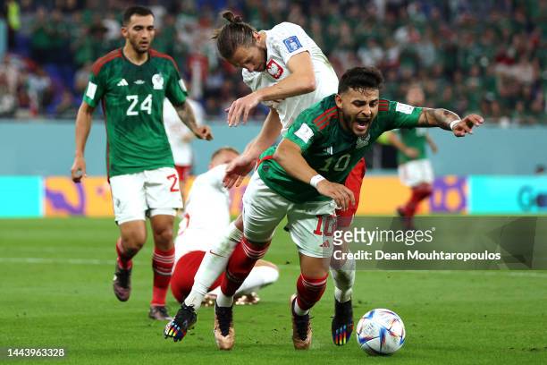 Alexis Vega of Mexico battles for the ball with Grzegorz Krychowiak of Poland during the FIFA World Cup Qatar 2022 Group C match between Mexico and...