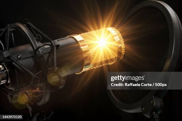 close-up of illuminated electric lamp against black background,rome,italy - raffaele corte stock pictures, royalty-free photos & images