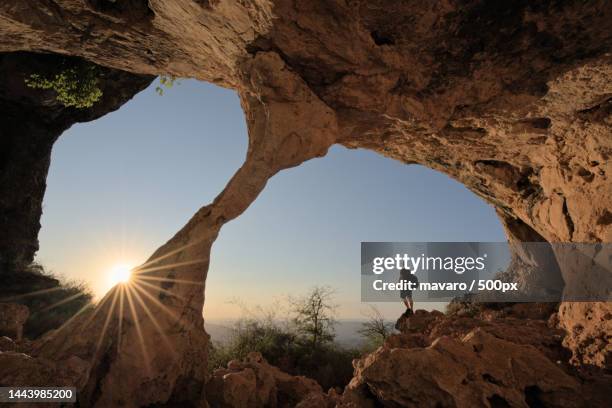 rear view of person standing on rock formation against sky,alcoy,alicante,spain - alcoy spain stock pictures, royalty-free photos & images