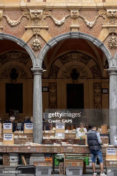 visitantes mirando carteles y libros antiguos en el mercado de antigüedades en la bolsa de vieille en lille - nord fotografías e imágenes de stock