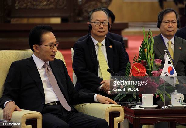 South Korea's President Lee Myung-bak attends a meeting with his Chinese counterpart Hu Jintao and Japan's Prime Minister Yoshihiko Noda during the...